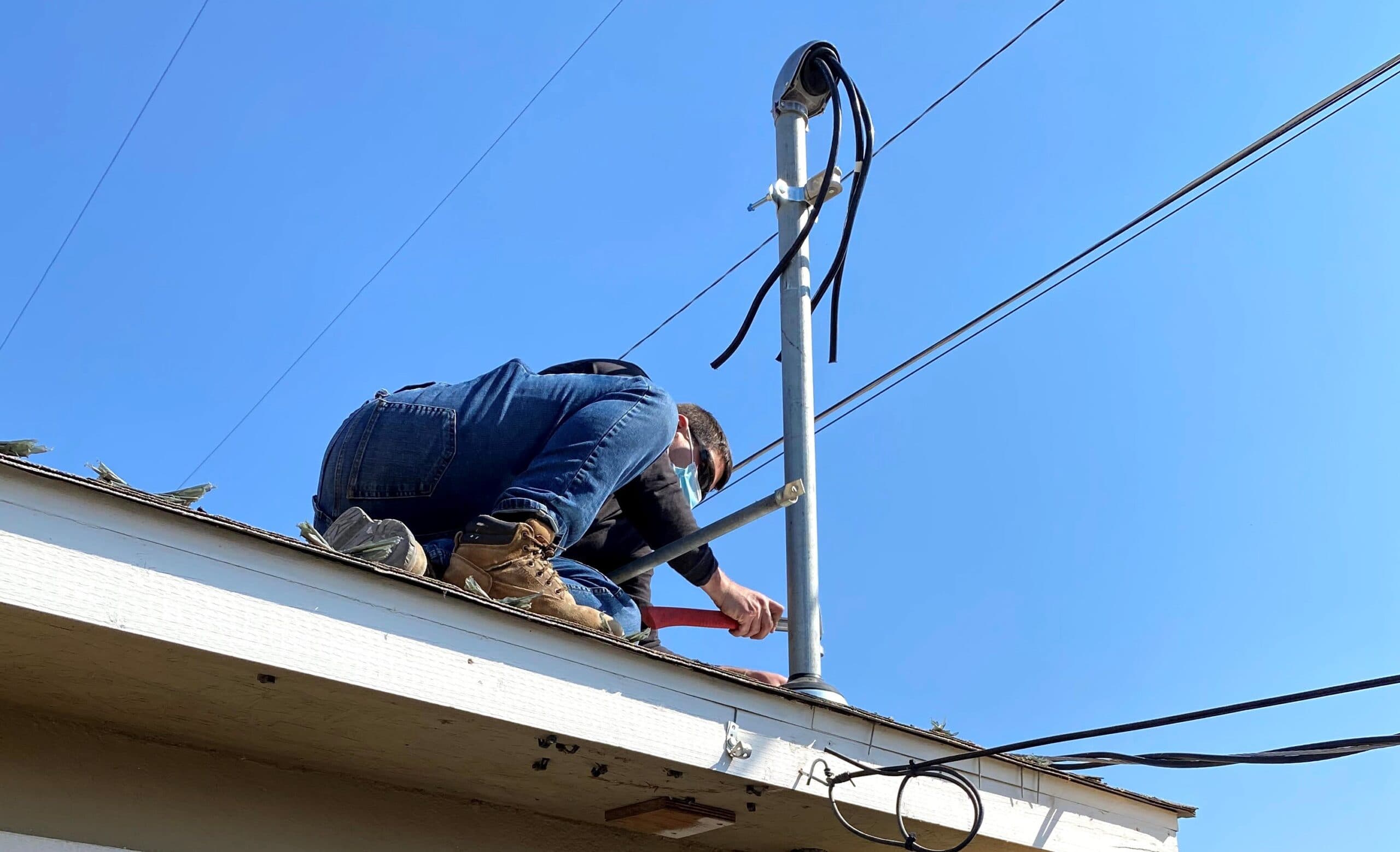 Electrician working on exterior service equipment